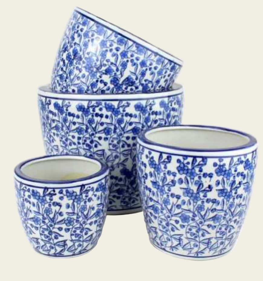Set of blue and white floral-patterned ceramic pots on a white background