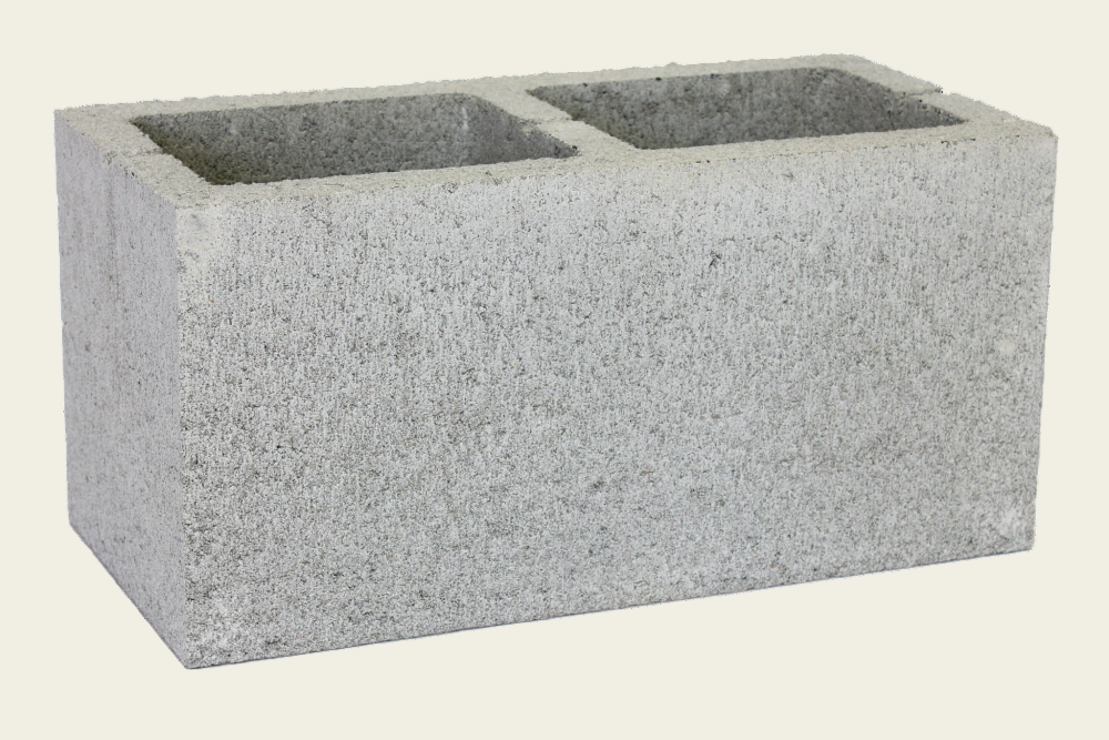 Concrete block with two rectangular cavities on a white background