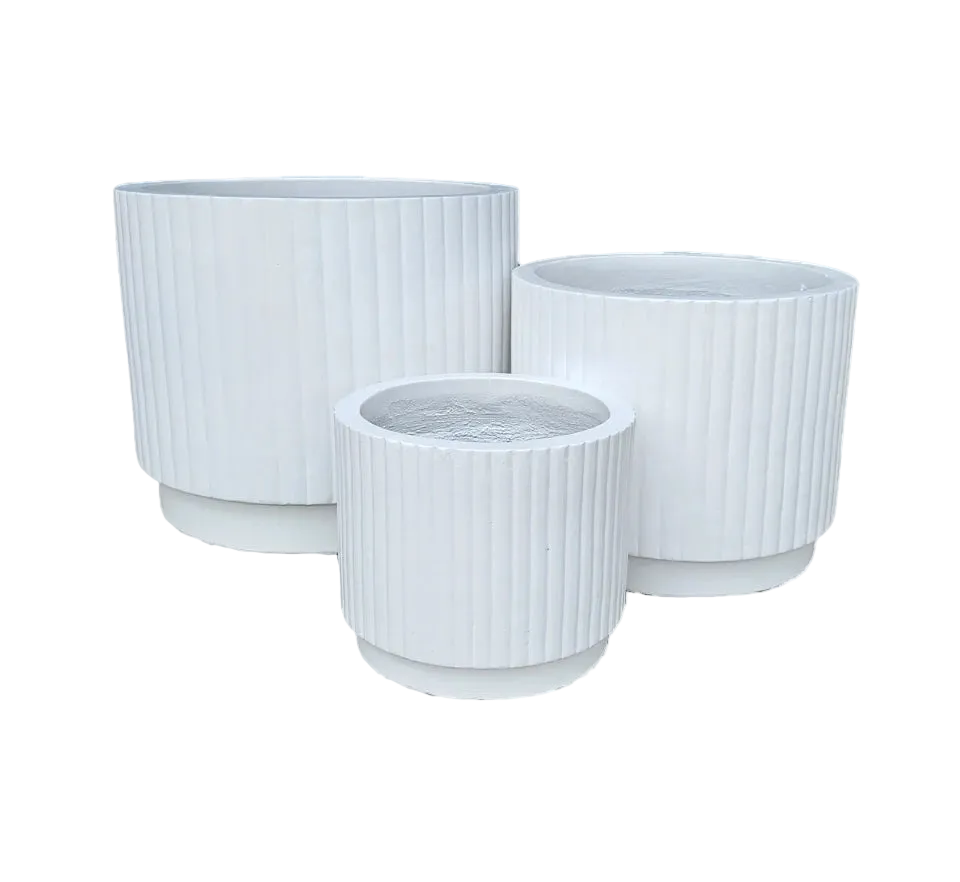 Three white ribbed planters of different sizes on a white background