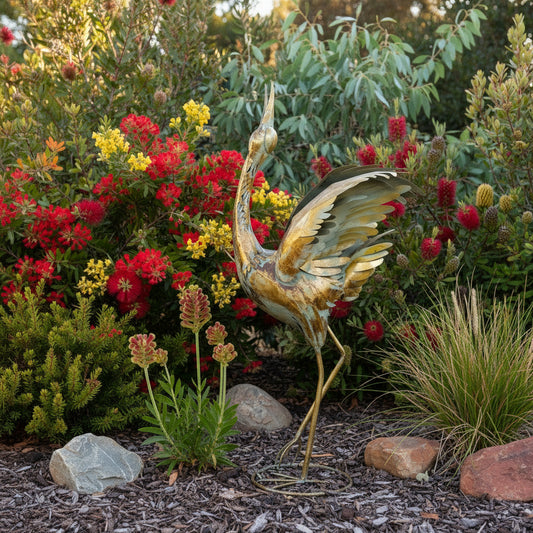 Gold bird sculpture in a native garden