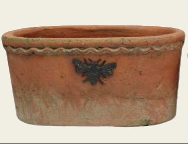 Two terracotta planters with bee designs on a white background