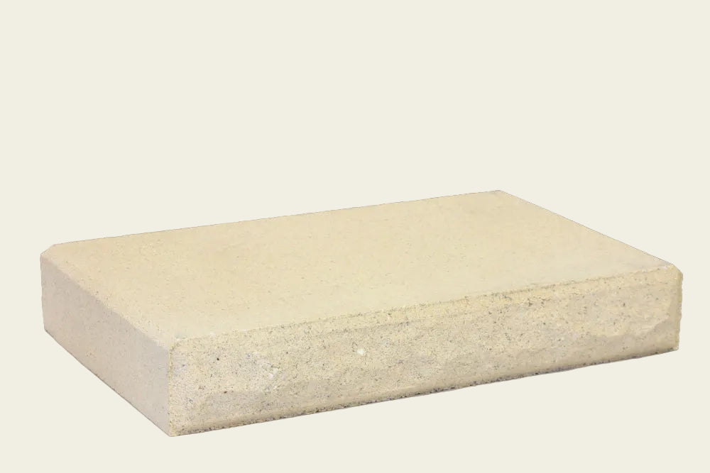 Rectangular beige concrete block on a white background