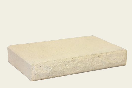 Rectangular beige concrete block on a white background